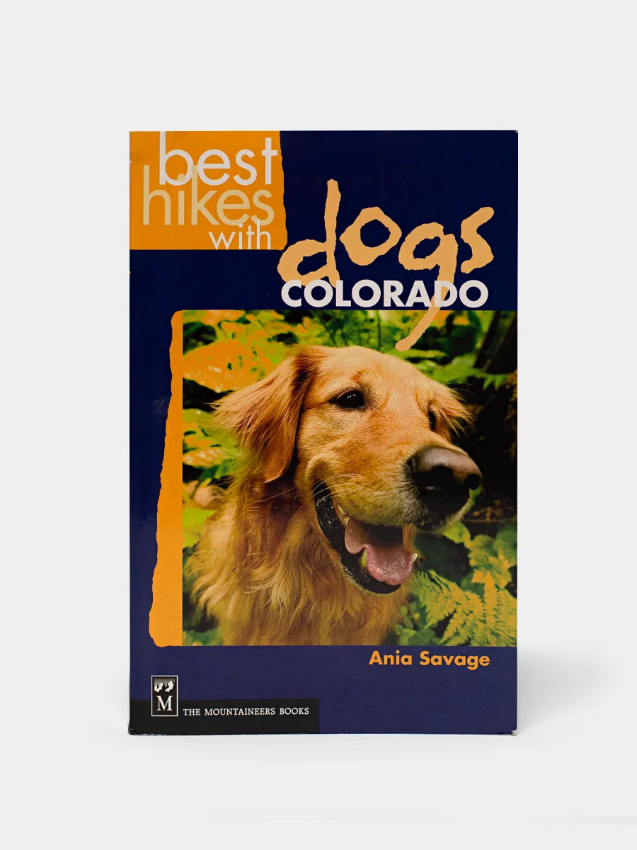 A book cover for 'Best Hikes with Dogs Colorado' featuring an image of a golden retriever dog smiling.