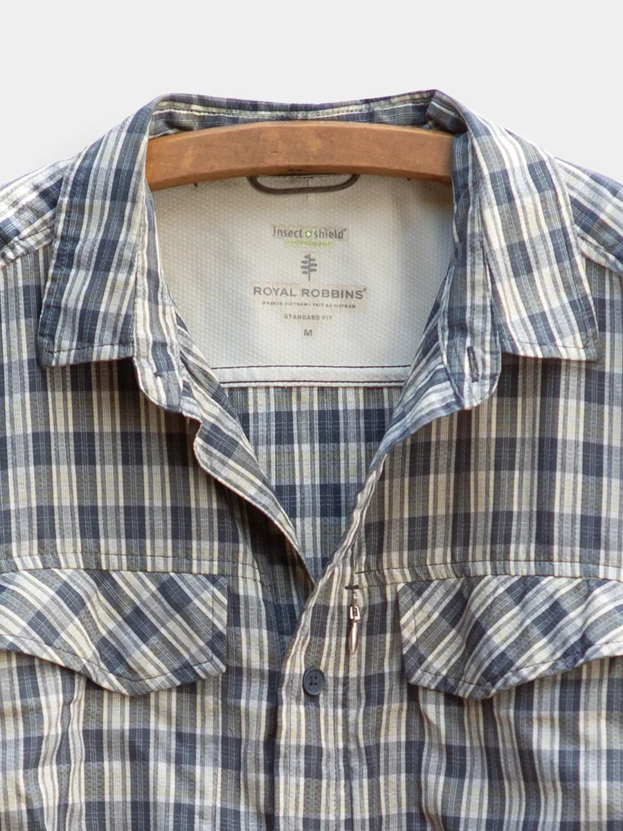 Detail Front View of Navy/Grey Hiking Shirt by Royal Robbins on a vintage wooden hanger with a hidden zip chest pocket.