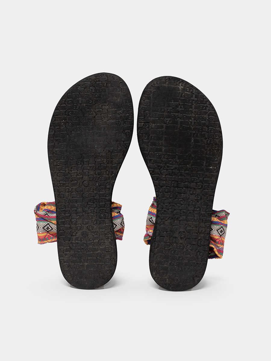 Black sandals with colorful straps on a white background