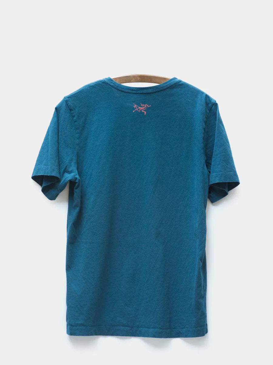 back view of Arc'teryx Blue Tee with the Bird logo in Pink at center back neck