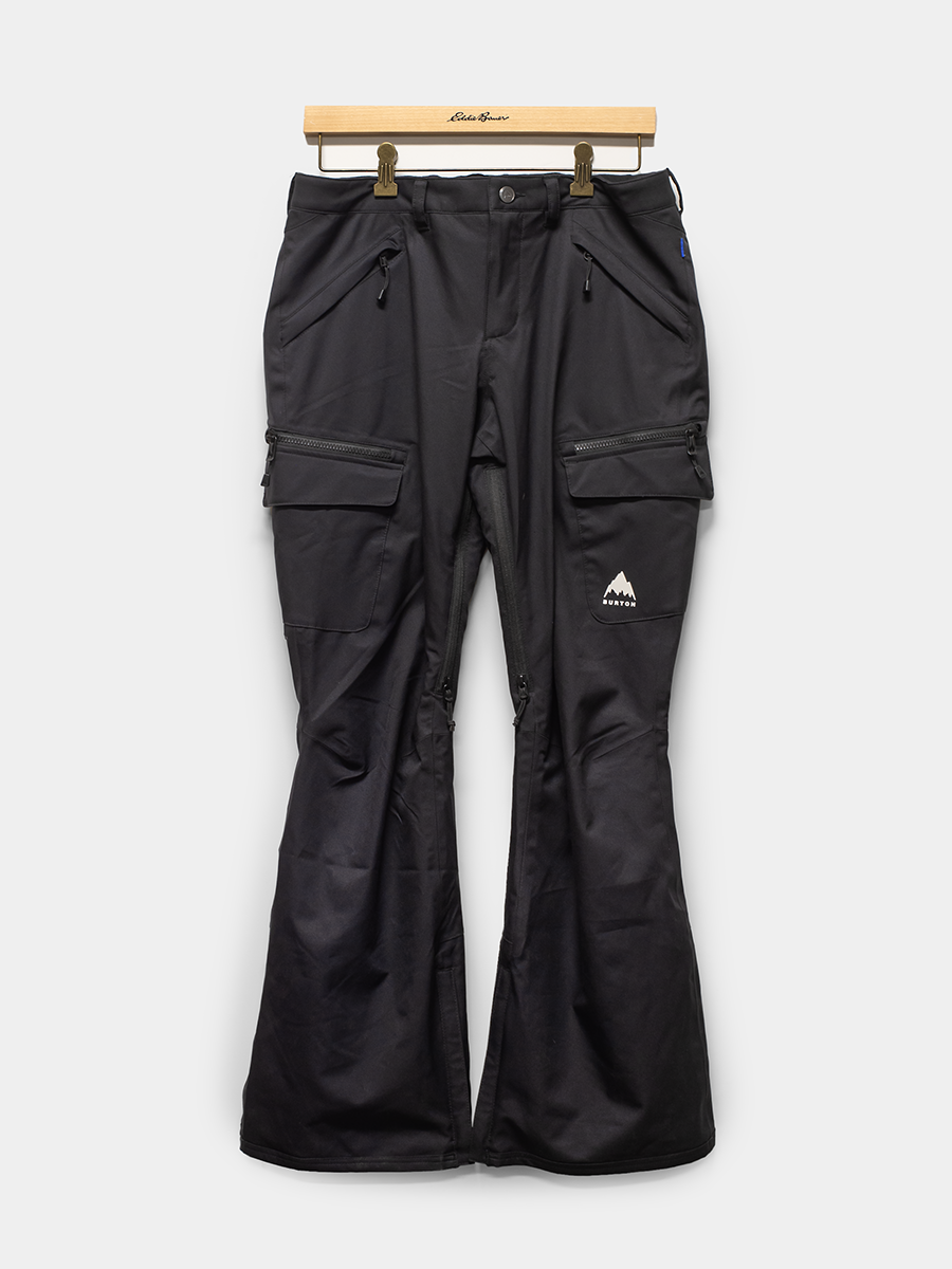 Black snow pants on a hanger against a white background