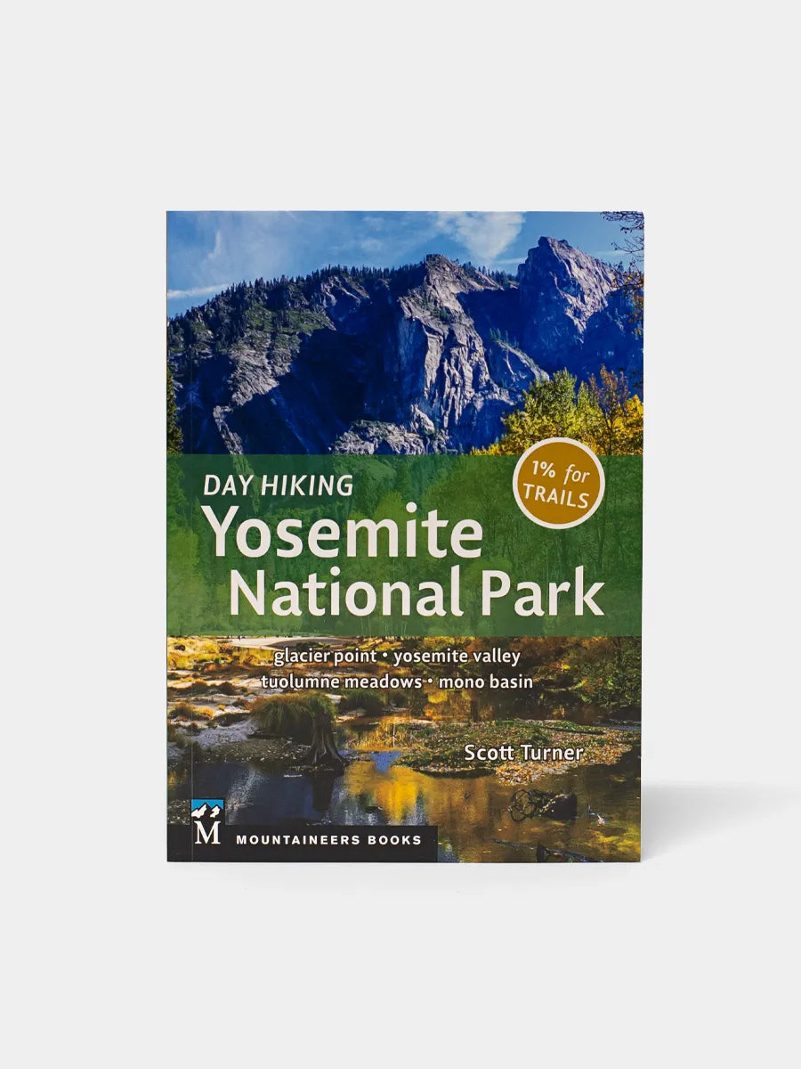 A book cover for 'Day Hiking Yosemite National Park' featuring a photograph of a mountain range with green trees in the foreground.