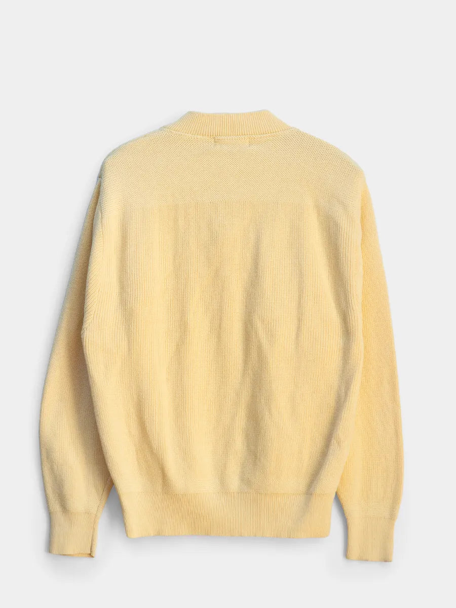 Yellow sweater on a light gray background