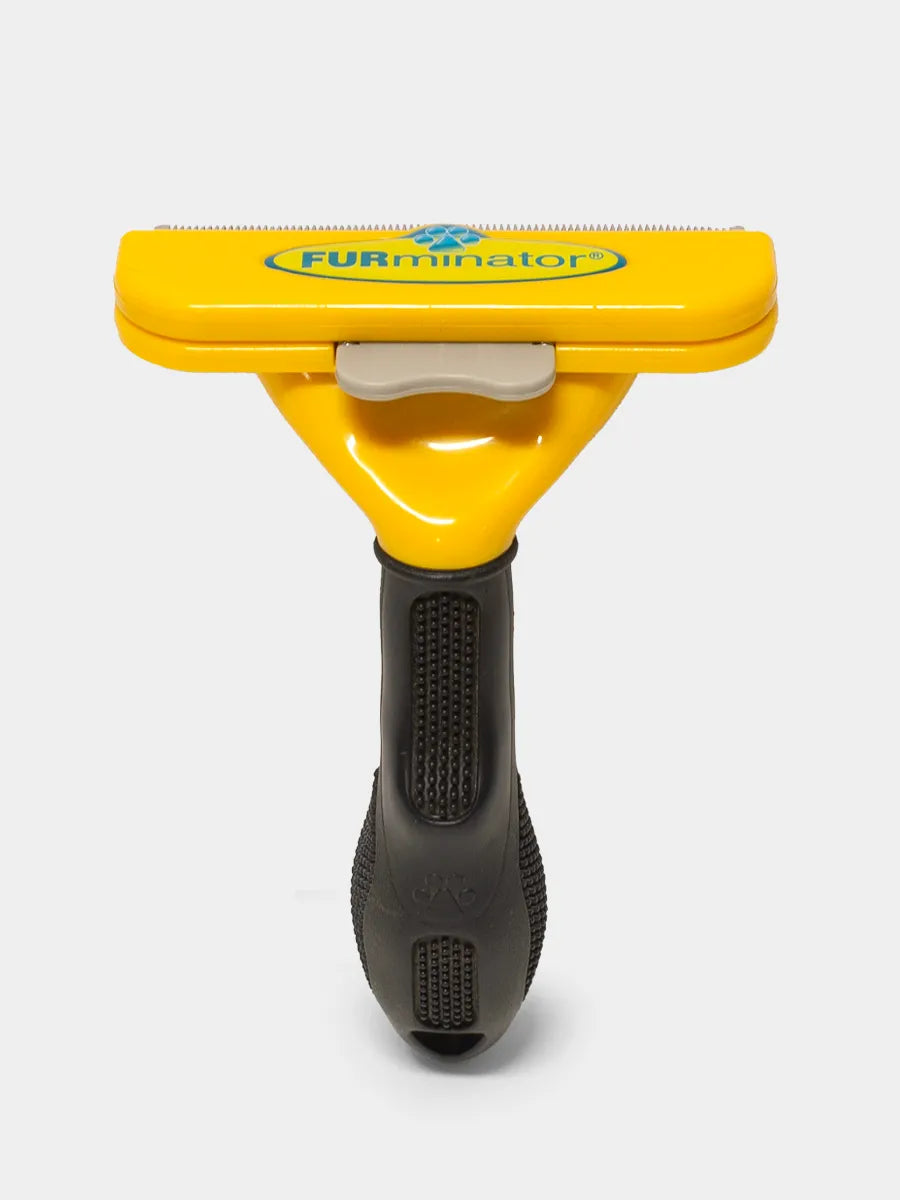 Yellow and black FURminator tool on a white background