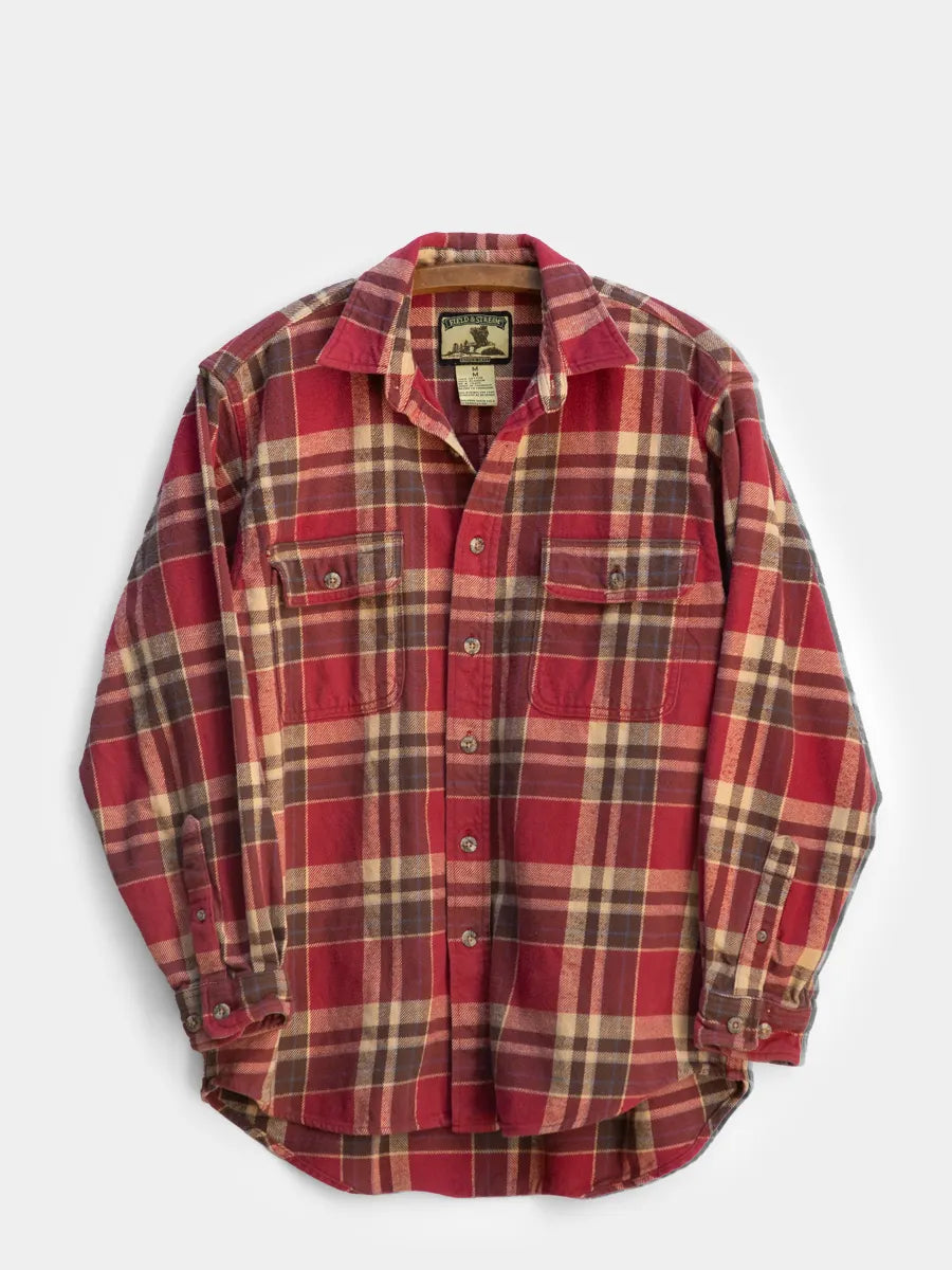 Front view of Red/brown/tan flannel heavy cotton shirt by Field & Stream hanging on a wooden hanger against a white background