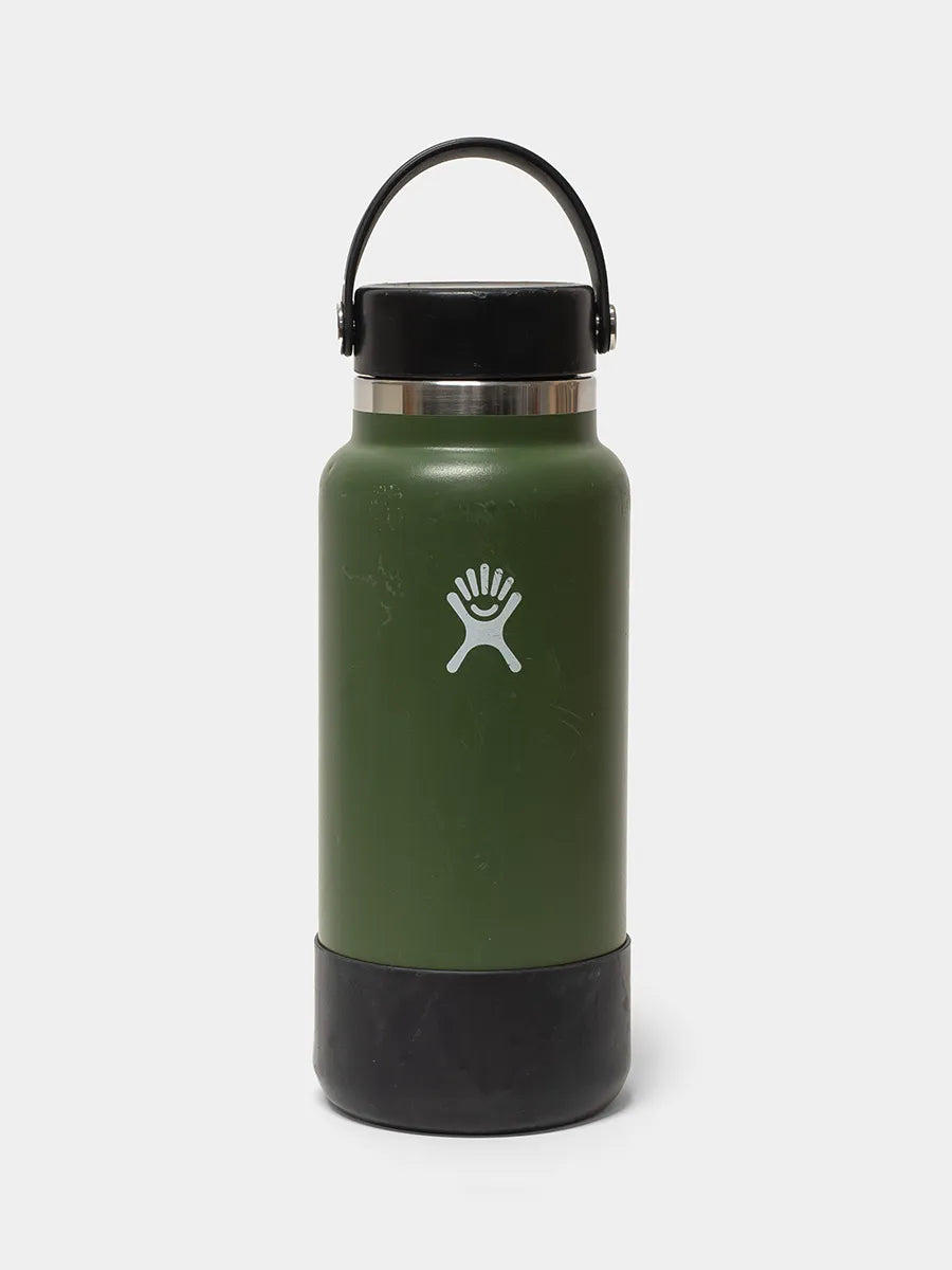 Green water bottle with black lid on a white background