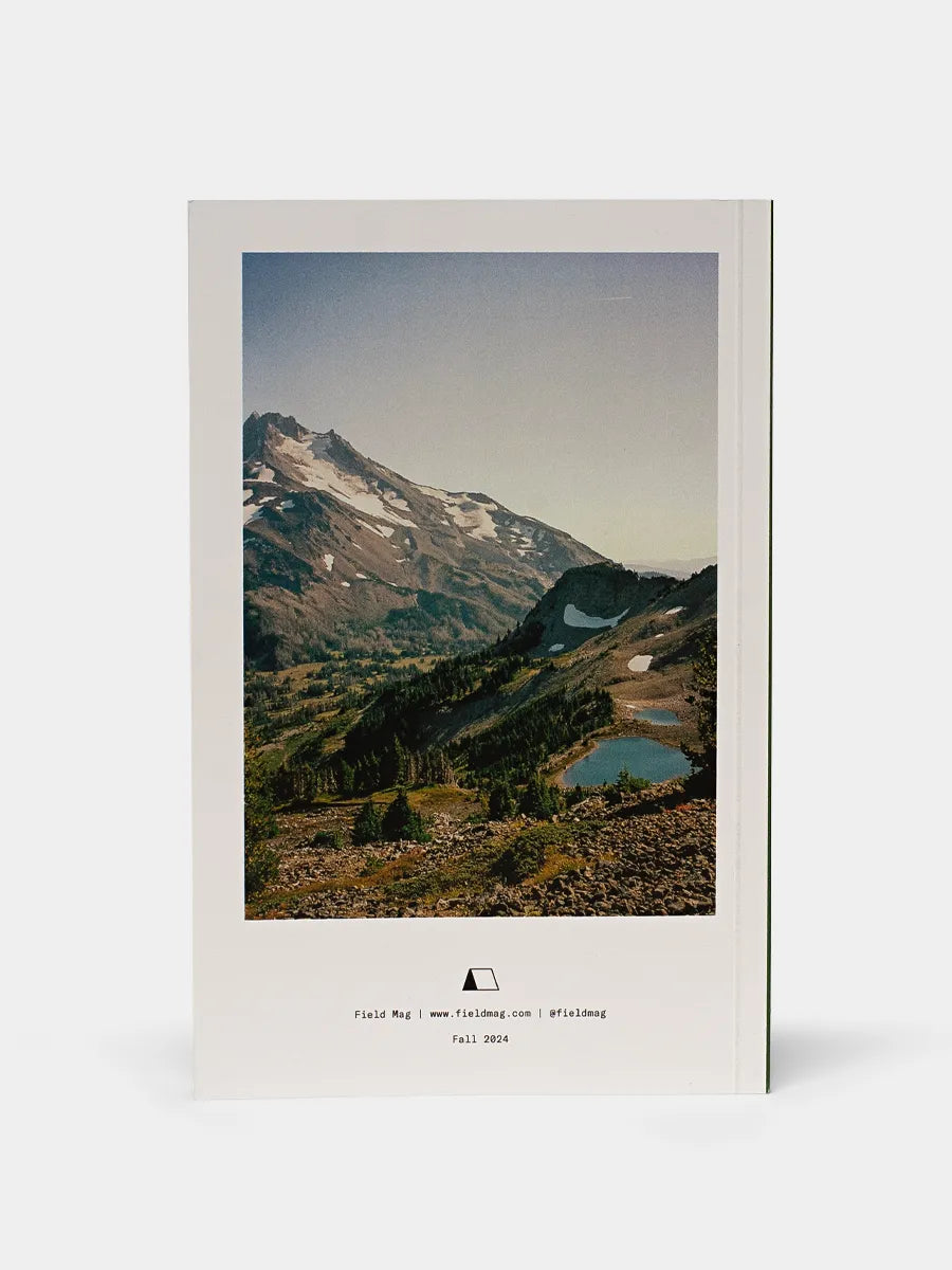 Back cover of FM03 Hike Zine depicts a small blue lake tucked into the mountain side.