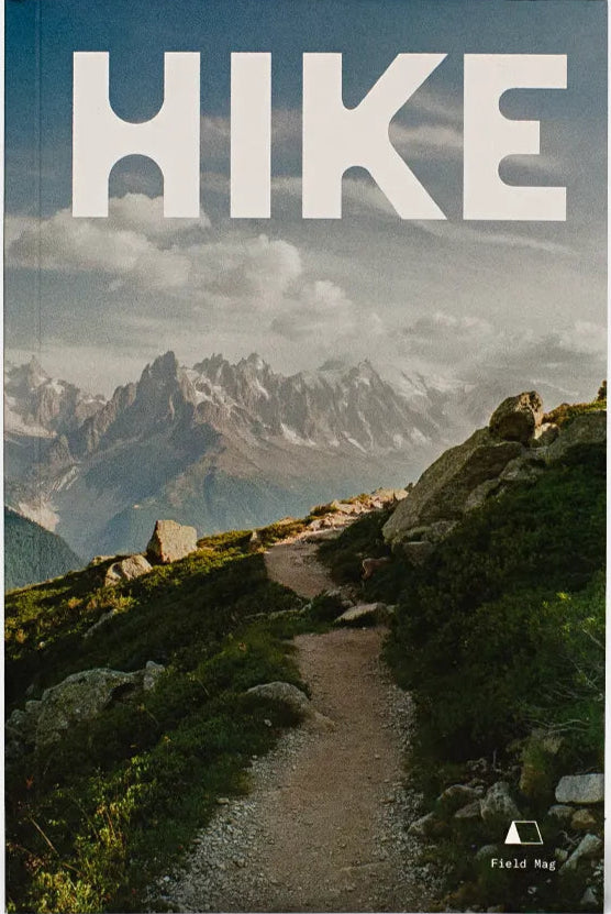 Front cover of FM03 Hike Zine by Field Mag shows a photo of a dirt trail that leads into a backdrop of mountains in the far distance.