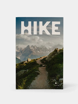 Front cover of FM03 Hike Zine by Field Mag shows a photo of a dirt trail that leads into a backdrop of mountains in the far distance.