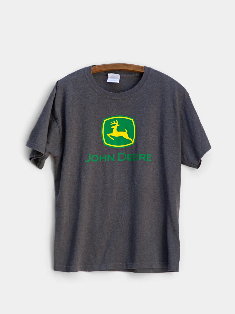 Charcoal heather gray t-shirt featuring the John Deere deer logo in green and yellow, with "JOHN DEERE" text on the front. White background
