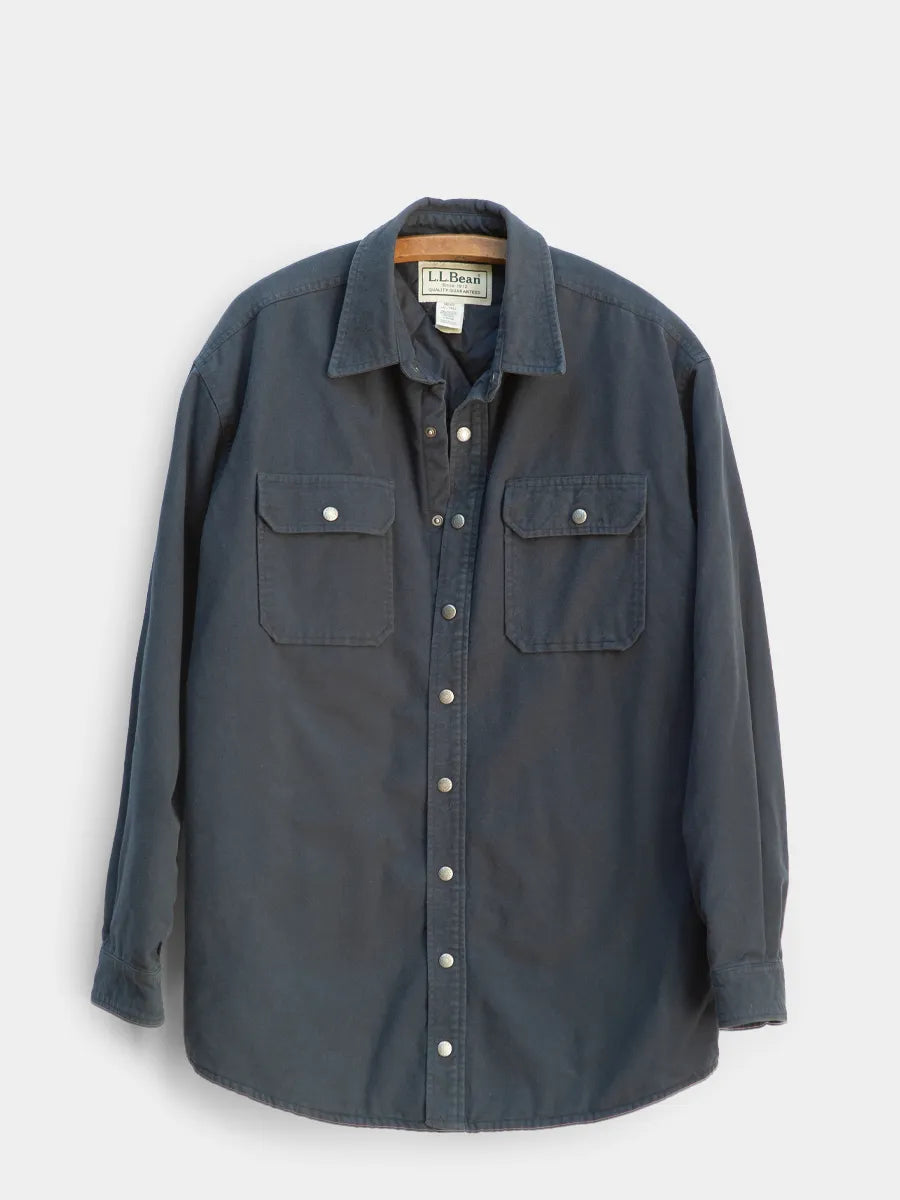 Dark blue shirt with button details on a white background