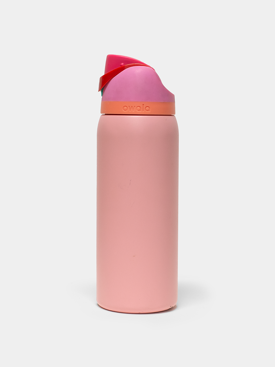 Pink Owala water bottle with a red and pink cap on a white background
