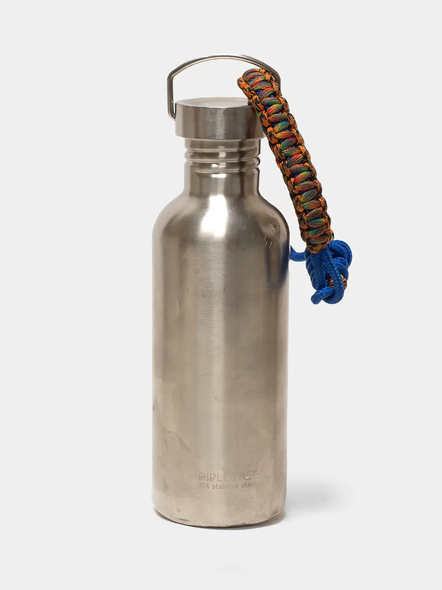 Silver water bottle with a colorful paracord handle on a white background