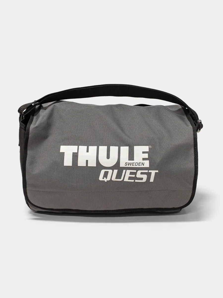Front view Thule 846 Quest rooftop cargo bag packed inside its gray and black zippered storage case, displayed on a white background

