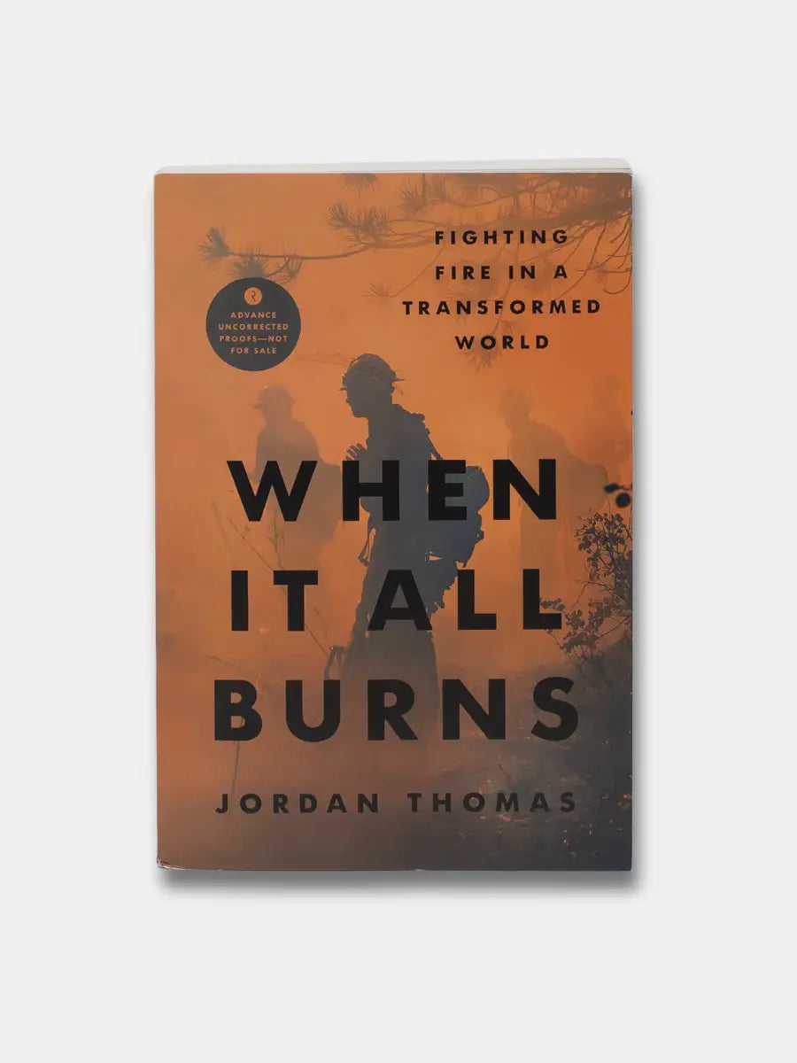 Book cover of 'When It All Burns' by Jordan Thomas with a silhouette of a person against an orange background.