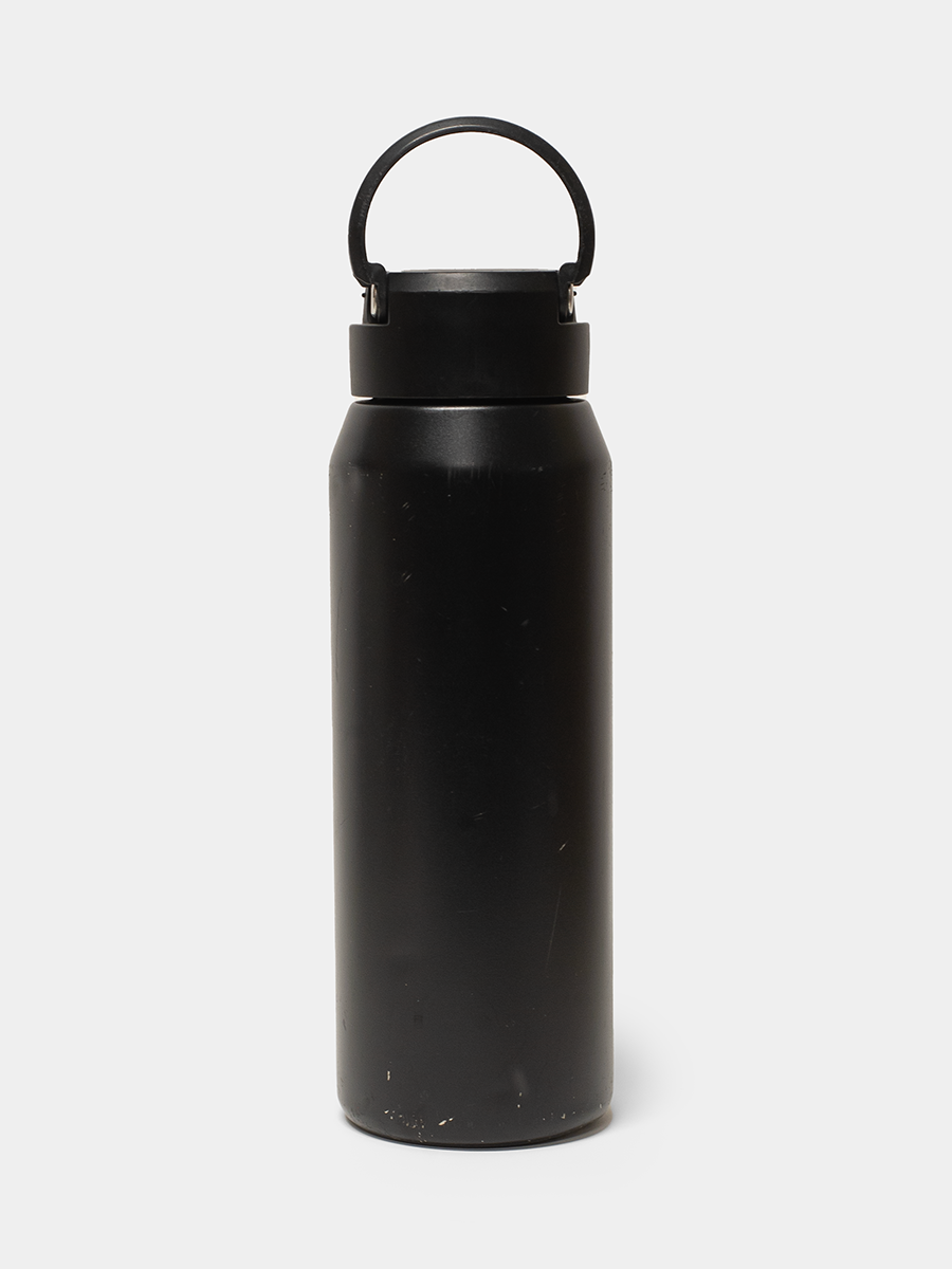 Black water bottle with a black lid on a white background