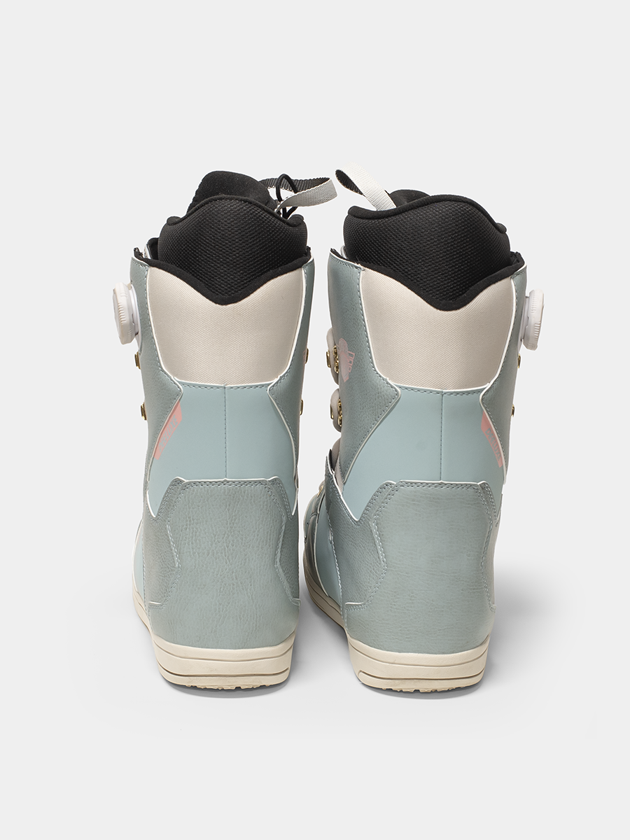 Back view of Deeluxe snowboard boots with a light blue/pink/white color scheme on a white background