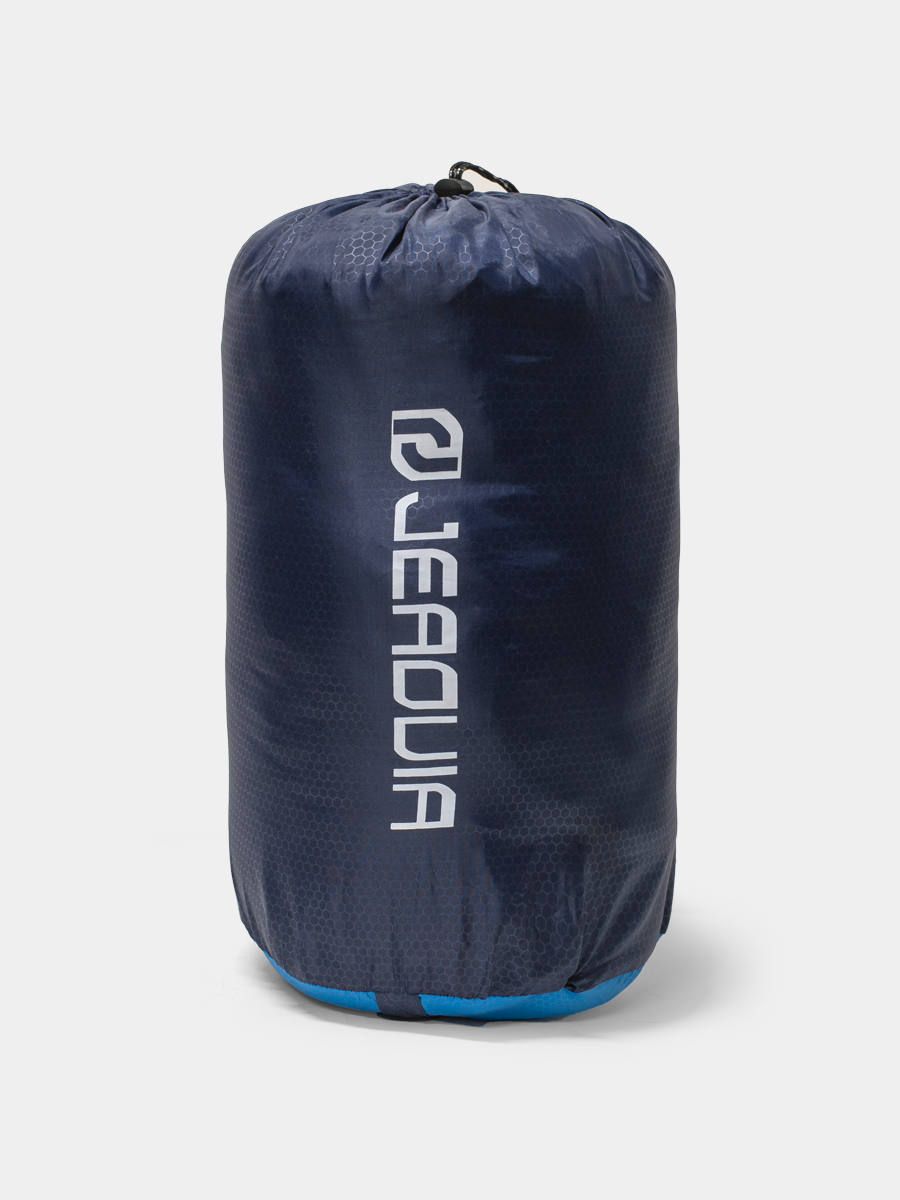 Blue and black packable bag with Quechua branding on a light gray background