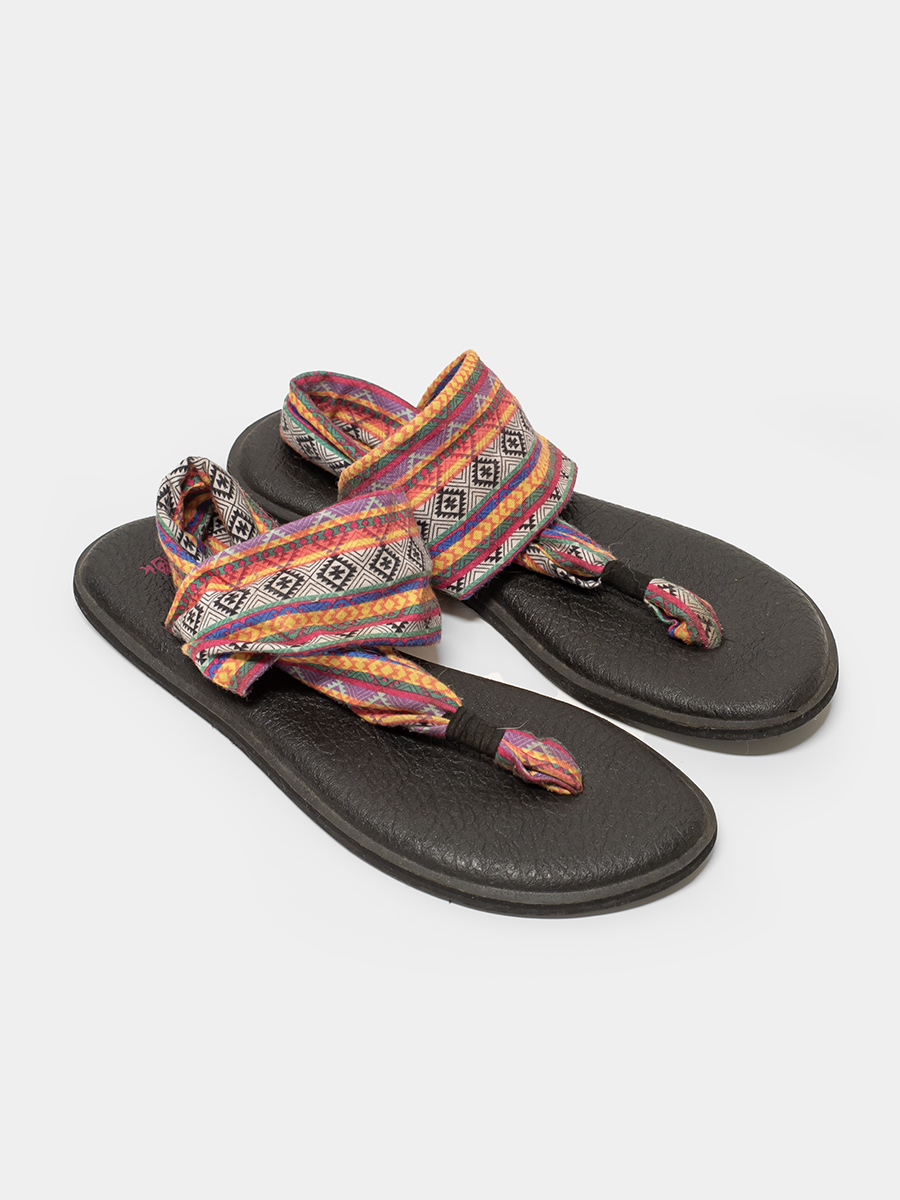 Pair of Sanuk sandals with colorful patterned straps on a white background