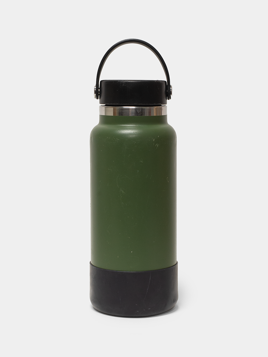 Green water bottle with black base and handle on a white background