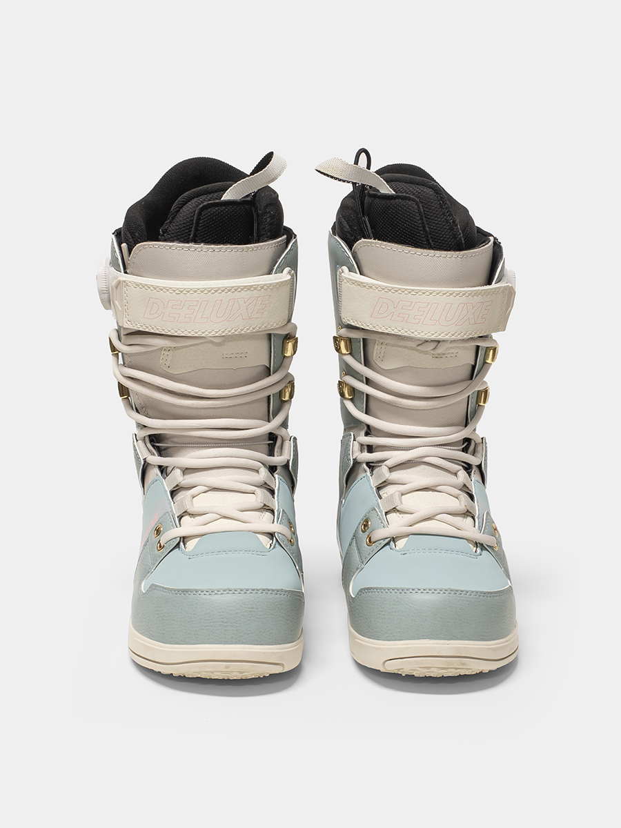 Pair of Deeluxe snowboard boots with a light blue and off white color scheme on a white background