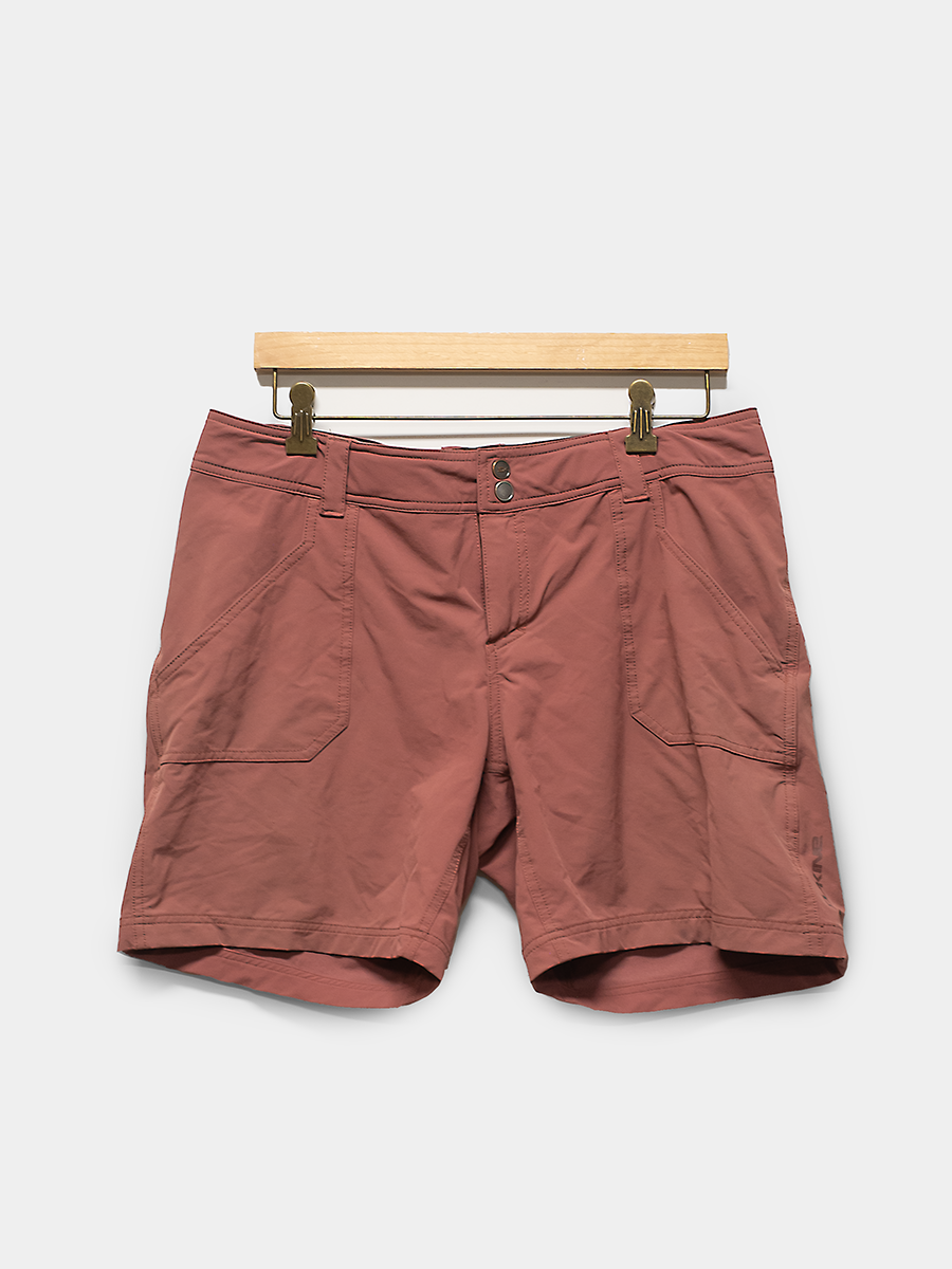 Brown shorts on a hanger against a white background