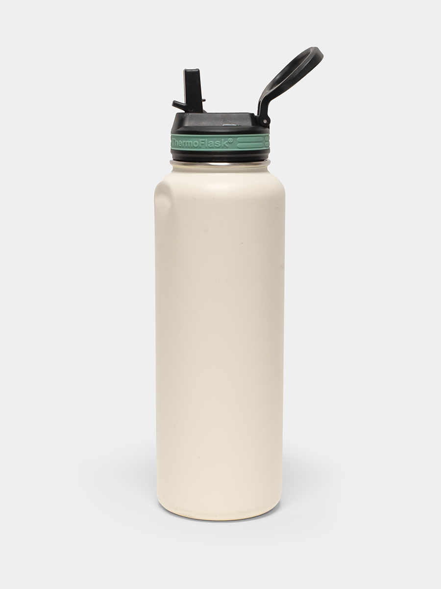 thermoflask creme bottle with green rim and black lid on white background